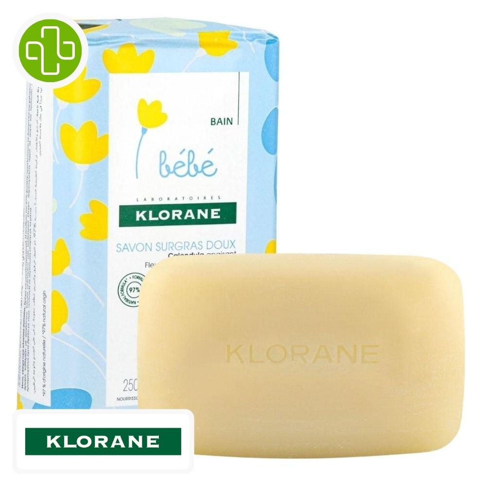 Produit de la marque klorane bébé savon surgras doux au calendula - 250g sur un fond blanc avec un logo parachezvous et celui de de la marque klorane