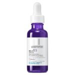 Produit de la marque La Roche-Posay Pure Niacinamide 10 Sérum Anti-Taches Réparateur - 30ml sur un fond blanc avec un logo Parachezvous et celui de de la marque La Roche-Posay